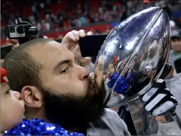  ?? AP PHOTO/PATRICK SEMANSKY ?? New England Patriots’ Lawrence Guy kisses the trophy after the NFL Super Bowl 53 football game against the Los Angeles Rams, on Sunday in Atlanta.