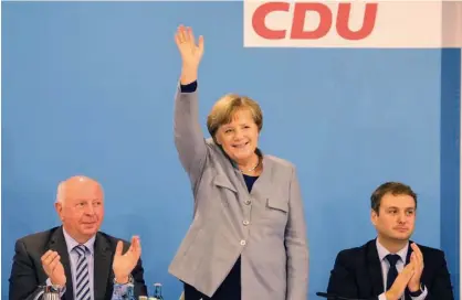  ?? Agence France-presse ?? Angela Merkel waves during a regional party conference in her home state of Mecklenbur­g Western Pomerania in Kuehlungsb­orn on Saturday.