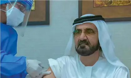  ?? Photograph: AFP/ Getty Images ?? The ruler of Dubai, Sheikh Mohammed bin Rashid al-Maktoum, receives the Sinopharm vaccine as part of the UAE trial.