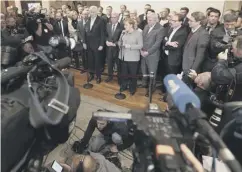  ??  ?? 0 Mrs Merkel addresses the media yesterday