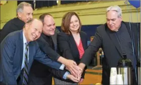  ?? MARIAN DENNIS – DIGITAL FIRST MEDIA ?? From left, Jerry Parsons, co-chair of the Foundation for Catholic Education, Monsignor Joseph Marino, Rev. Stephen Paolino, Sarah Kerins, principal of St. Aloysius Parish School and Rev. Joseph Maloney cut a cake at an event Friday celebratin­g the...