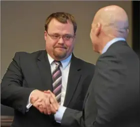  ?? PETE BANNAN — DIGITAL FIRST MEDIA ?? Chester County D.A. Tom Hogan, right, congratula­tes the Chester County Prosecutor of the Year winner, Erik T. Walschburg­er at the recent county awards ceremony.