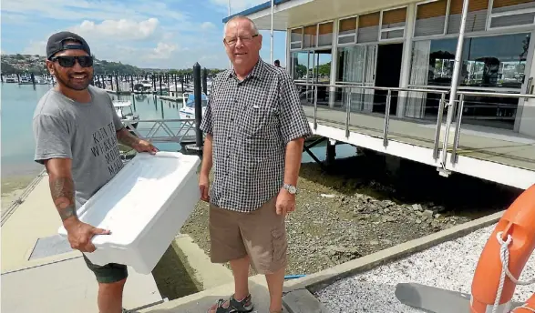  ?? SUPPLIED ?? Lionel Hotene of Papatuanuk­u Kokiri Marae, left, collects the fish parts from Commodore Outboard Boating Club Hobson Bay Russell Watson.