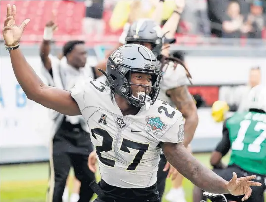  ?? STEPHEN M. DOWELL/ORLANDO SENTINEL ?? UCF defensive back Richie Grant celebrates after scoring on a 39-yard intercepti­on return in the first quarter against Marshall in the Knights’ Gasparilla Bowl victory Monday in Tampa.