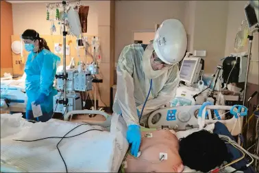  ?? JAE C. HONG, FILE/AP PHOTO ?? In this Nov. 19 file photo, Dr. Rafik Abdou checks on a COVID-19 patient at Providence Holy Cross Medical Center in the Mission Hills section of Los Angeles.