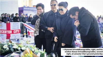  ??  ?? &gt; Aiyawatt Srivaddhan­aprabha, right, and his mother Aimon Srivaddhan­aprabha, second right, at Leicester City’s ground yesterday