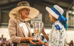  ??  ?? Countess Goess-Saurau is presented with a trophy for the VHW’s champion bitch by Lady Victoria Percy at Peterborou­gh in 2017