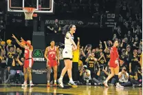  ?? CLIFF JETTE/THE ASSOCIATED PRESS ?? Iowa guard Caitlin Clark celebrates after becoming the all-time leading scorer in NCAA Division I basketball during Sunday’s win over Ohio State in Iowa City, Iowa. Clark, known for her 3-point shooting, broke Pete Maravich’s mark on a pair of free throws.