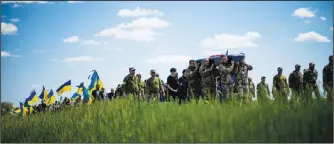  ?? (AP/Francisco Seco) ?? Ukrainian soldiers carry the coffin of Volodymyr Losev, 38, on May 16 during his funeral in Zorya Truda in the Odesa region of Ukraine. The 38-year-old Ukrainian volunteer soldier was killed May 7 when the military vehicle he was driving ran over a mine in eastern Ukraine.