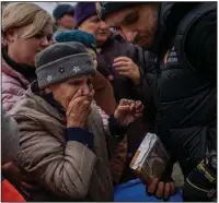  ?? (AP/Bernat Armangue) ?? A woman receives food donations Thursday from World Central Kitchen in Kherson in southern Ukraine. Reports of enforced disappeara­nces, torture and other abuses are being investigat­ed in the recently liberated city.