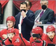  ?? Karl B DeBlaker / Associated Press ?? Carolina Hurricanes coach Rod Brind’Amour, center, watches play from behind the bench during the third period against the Detroit Red Wings during a game in April.