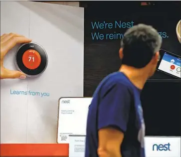  ?? Justin Sullivan Getty Images ?? THE NEST Learning Thermostat is on display at a Home Depot store in 2014 in San Rafael, Calif.
