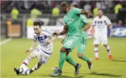  ??  ?? LYON: Lyon’s Mathieu Valbuena, left, challenges for the ball with Saint-Etienne’s Florentin Pogba, center, during their French League One soccer match at Gerland stadium, in Lyon, central France, Sunday. — AP