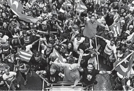  ?? DENNIS M. RIVERA PICHARDO/AP ?? A crowd celebrates the resignatio­n of Gov. Ricardo Rossello in Puerto Rico, a U.S. territory of over 3 million Americans.
