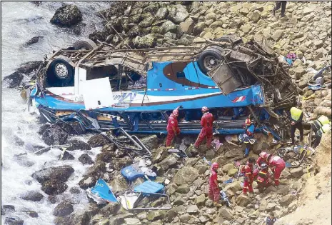  ?? AFP ?? Rescuers work at the scene of a bus crash in Lima on Tuesday.