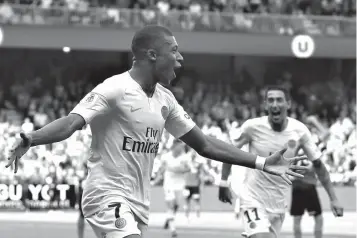  ?? Associated Press ?? ■ PSG's Kylian Mbappe celebrates after scoring the second goal for his team during their League One soccer match between Guingamp and Paris Saint Germain on Saturday at Roudourou stadium in Guingamp, western France.