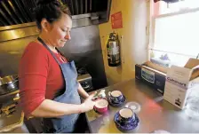  ??  ?? Jelly Chavez, general manager at Kakawa, scoops out a serving of lemon ice sorbet and prickly pear sorbet at Kakawa on Tuesday. Kakawa serves sorbet seasonally and takes advantage of local produce.