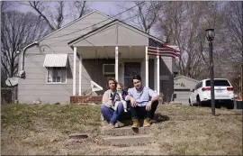  ?? CHARLIE RIEDEL — THE ASSOCIATED PRESS ?? Logan DeWitt with his wife Mckenzie and daughter Elizabeth at their home in Kansas City, Kan. Because he could work at home, Logan kept his job through the pandemic while his wife lost hers and went back to school. Their financial situation was further complicate­d with the birth of their daughter nine months ago.