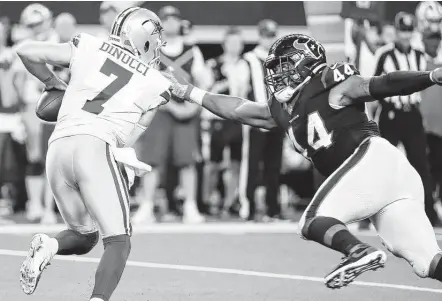  ?? Brett Coomer / Staff photograph­er ?? DeMarcus Walker pressures Cowboys quarterbac­k Ben DiNucci during the second half. Walker recorded one of the Texans’ five sacks.