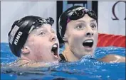  ?? Christophe Simon AFP/Getty Images ?? KATIE MEILI, right, reacts to Lilly King’s recordbrea­king time in the 100-meter breaststro­ke in Rio.