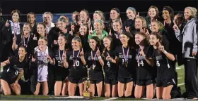  ?? AUSTIN HERTZOG — MEDIANEWS GROUP ?? The Pennridge girls soccer team poses with the District 1 trophy after repeating as champion Thursday night in a 2-0 win over Spring-Ford.