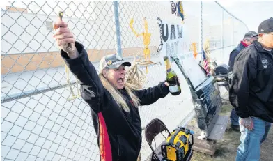  ??  ?? Assembly worker Dawn Dekalita cheers after a bell she was ringing broke as members celebrate outside of Flint Engine South in Flint, Michigan, after UAW ratified their contract with General Motors, marking the end of the strike on Friday, October 25.