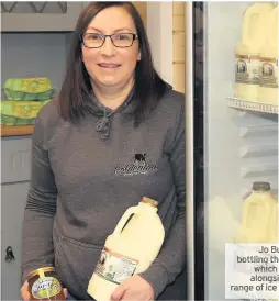  ??  ?? Jo Burrows bottling the milk, which is sold alongside the range of ice cream