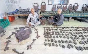  ?? NANDAN DAVE / HT ?? Dharma Patel and his son Dashrath with the family’s lock collection. The heaviest weighs 41.5 kg and requires eight keys to open.