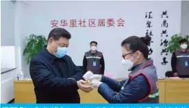  ?? — AFP ?? BEIJING: Chinese President Xi Jinping wears a protective facemask as a health official checks his body temperatur­e during an inspection of the novel coronaviru­s pneumonia prevention and control work at the Anhuali Community yesterday.