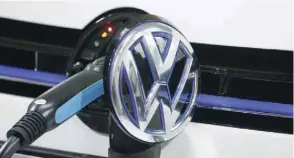  ?? — Reuters ?? A Volkswagen Golf GTE is being charged during a workshop in Guangzhou.