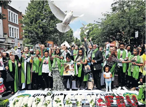  ??  ?? Doves are released to commemorat­e the anniversar­y of the Grenfell Tower fire, just streets away from the burnt out shell of the building