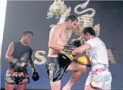  ??  ?? Australia’s Marinko Matosevic, centre, attends a Muay Thai class led by superstar fighter Buakaw Banchamek, left.