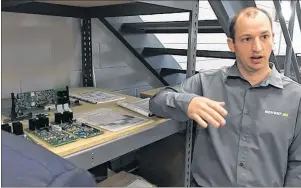  ?? CP PHOTO ?? Dr. Chris Burns, president and CEO Novonix Battery Testing Services Inc., explains the company’s high-precision battery testing equipment in Dartmouth, N.S., Tuesday.