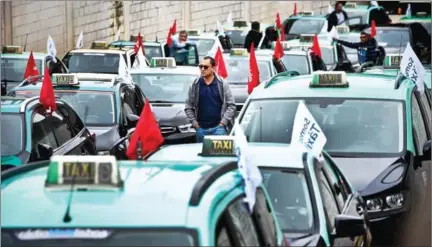  ?? PATRICIA DE MELO MOREIRA/AFP ?? Taxi drivers take part in a go-slow action in Lisbon in October to protest against the legalisati­on of car-booking chauffeure­d service Uber, accused of ‘unfair competitio­n’.