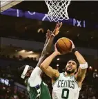  ?? Stacy Revere / Getty Images ?? The Celtics’ Jayson Tatum is defended by the Bucks’ Bobby Portis during the second quarter in Game 6 of the Eastern Conference semifinals riday.