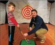  ?? PAUL POST — PPOST@DIGITALFIR­STMEDIA.COM ?? Jacob Parsons, 5, of Watervliet gets a golf lesson from PGA pro Kevin Haller of Saratoga Springs.