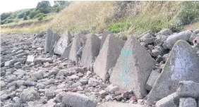  ??  ?? Sand has washed away on Oglet Shore in Speke, revealing antitanker barriers underneath. Image courtesy of Lynne Moneypenny