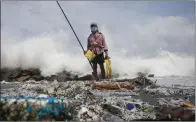  ?? AP/Eranga Jayawarden­a) ?? Fisherman Kindston Jayalath tries his luck Friday on a beach on the outskirts of Colombo, Sri Lanka, that has been polluted by plastic pellets from a sinking container ship. Jayalath said there are now no fish in the area.