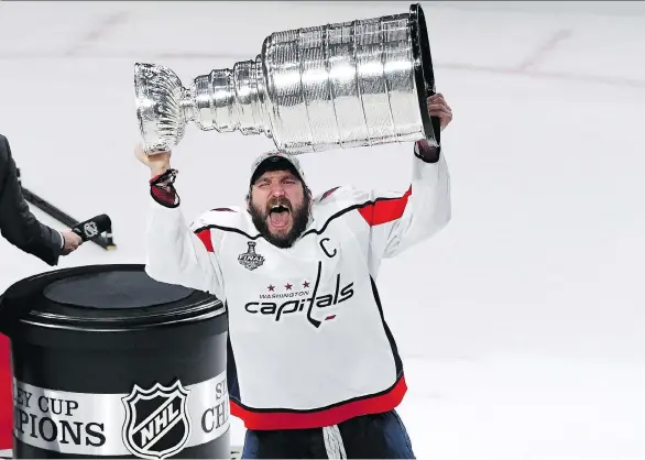  ?? ETHAN MILLER/GETTY IMAGES ?? Washington captain Alex Ovechkin hoists the Stanley Cup high above his head on Thursday night in Las Vegas after leading his team to a 4-3 victory in Game 5 to clinch the series. The Capitals’ captain was named the Conn Smythe Trophy winner as the...