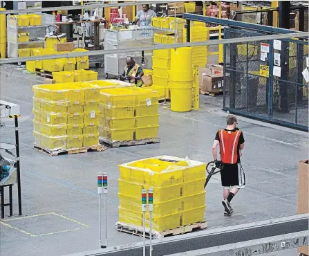  ?? REESS ADLER BLOOMBERG ?? Retailers know children have phones and use them, so are developing shopping apps for them. The Washington Post’s Abha Bhattarai reports many parents are allowing very young children to shop online. Above, an Amazon warehouse.