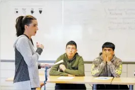  ?? LUIS SÁNCHEZ SATURNO THE NEW MEXICAN ?? Students Juan Luis Villegas Montoya, center, and Edgar Zamarripa, both 14, listen while Jessica Garcia, left, teaches a restorativ­e justice class Thursday at Nina Otero Community School.