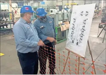  ?? Doug Walker ?? F&P Georgia Senior Plant Manager Nat Massey (left) checks out schematics of two of the three new weld lines that are being added to the Rome plant to supply parts to another major automotive manufactur­er.