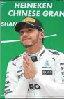  ?? ALY SONG / REUTERS ?? Mercedes driver Lewis Hamilton celebrates on the podium after winning the Chinese Grand Prix at Shanghai Internatio­nal Circuit last weekend.