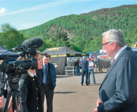  ??  ?? Above: Fergus Ewing talks to a BBC film crew at Aquacultur­e UK. Aviemore.