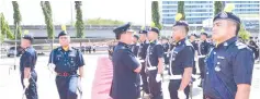  ??  ?? Zaini inspecting a police parade during his visit to Kota Kinabalu district police headquarte­rs.