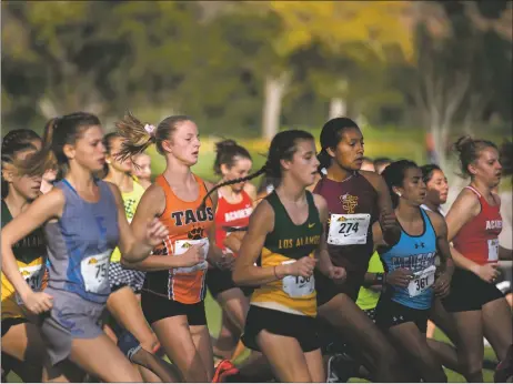  ?? MORGAN TIMMS/Taos News file photo ?? Taos freshman Alyx Mastor starts the race strong in 2019 during the Los Alamos Invitation­al cross-country meet at the Los Alamos Golf Course. Volleyball, cross-country and fall golf all were postponed to the spring after New Mexico Gov. Michelle Lujan Grisham announced restrictio­ns as the number of coronaviru­s cases begin to rise again in the state.