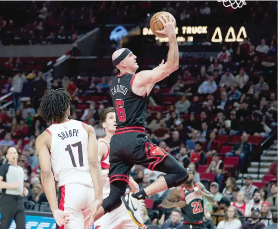  ?? CRAIG MITCHELLDY­ER/AP ?? Bulls guard Alex Caruso, driving to the hoop against the Trail Blazers, respects the Lakers’ Austin Reaves but doesn’t appreciate the recent comparison­s between them.