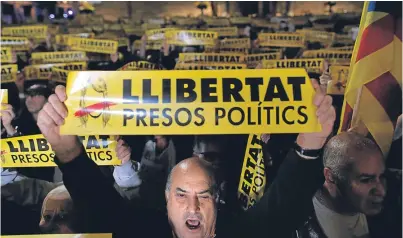  ?? Picture: Associated Press. ?? Demonstrat­ors hold banners calling for the release of Catalan political leaders during a protest in Barcelona.