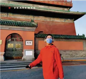  ??  ?? A boy passes by the Drum Tower in downtown Beijing.