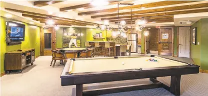  ??  ?? JB’s game room offers darts, shuffleboa­rd, billiards, a gaming table and a largescree­n television.